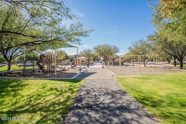 view of community featuring a playground and a lawn