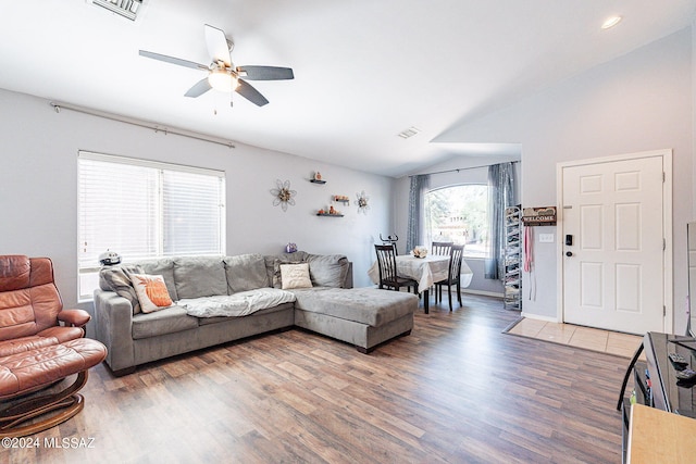 living room with ceiling fan, lofted ceiling, and dark hardwood / wood-style floors