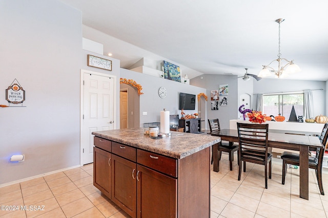 kitchen featuring pendant lighting, vaulted ceiling, a notable chandelier, and a center island