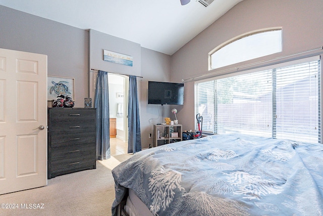 carpeted bedroom featuring high vaulted ceiling, ensuite bath, and ceiling fan