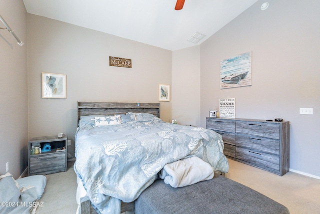 carpeted bedroom with ceiling fan and vaulted ceiling