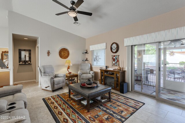 tiled living room featuring ceiling fan and vaulted ceiling