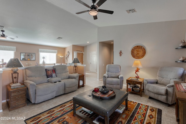 living room with ceiling fan, plenty of natural light, and light tile patterned flooring