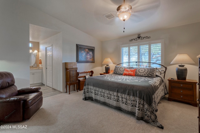 carpeted bedroom featuring lofted ceiling, ceiling fan, and ensuite bathroom