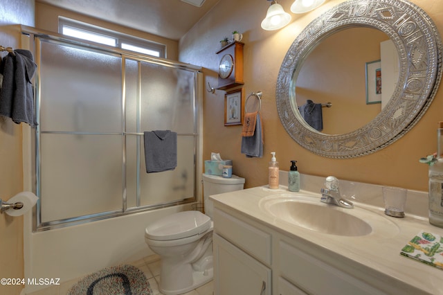 full bathroom with vanity, tile patterned flooring, toilet, and combined bath / shower with glass door