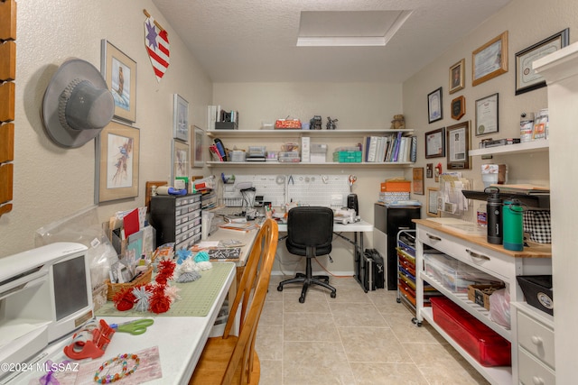 tiled office space with a textured ceiling