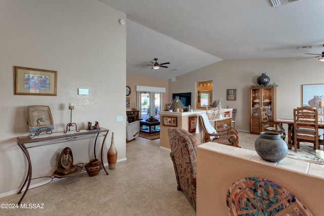 tiled living room featuring vaulted ceiling and ceiling fan