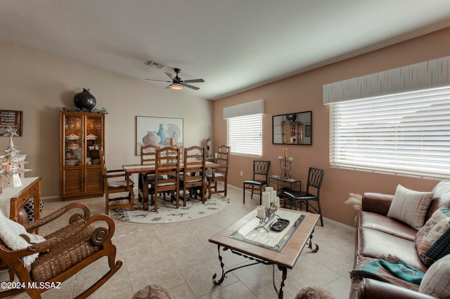 living room with light tile patterned floors, vaulted ceiling, and ceiling fan