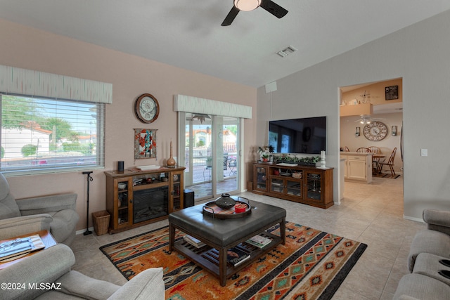 tiled living room featuring lofted ceiling and ceiling fan