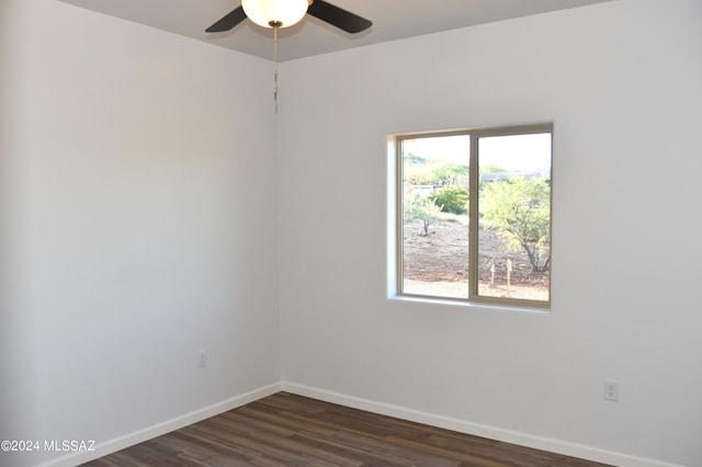 empty room with dark hardwood / wood-style flooring and ceiling fan