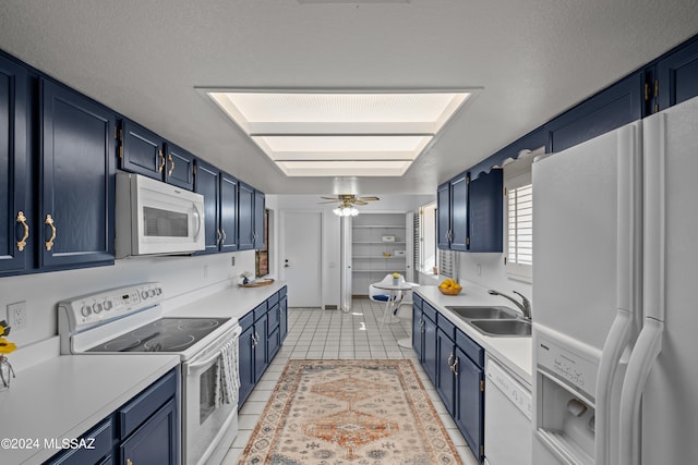 kitchen with blue cabinetry, ceiling fan, sink, white appliances, and light tile patterned floors