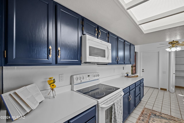 kitchen featuring light tile patterned floors, white appliances, and blue cabinets