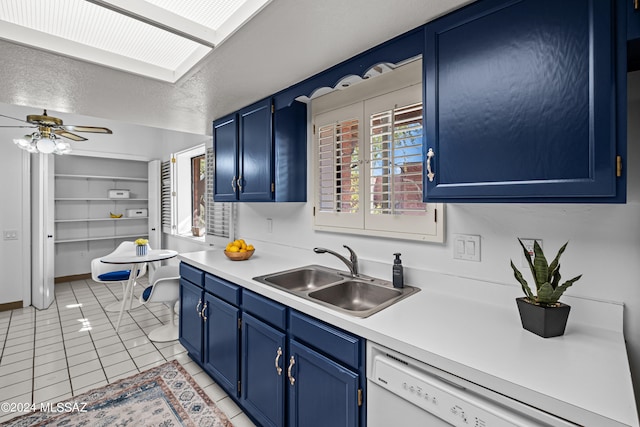 kitchen featuring blue cabinetry, light tile patterned floors, and sink