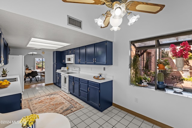 kitchen with blue cabinetry, light tile patterned floors, white appliances, and ceiling fan