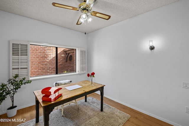 office space with hardwood / wood-style floors, a textured ceiling, and ceiling fan