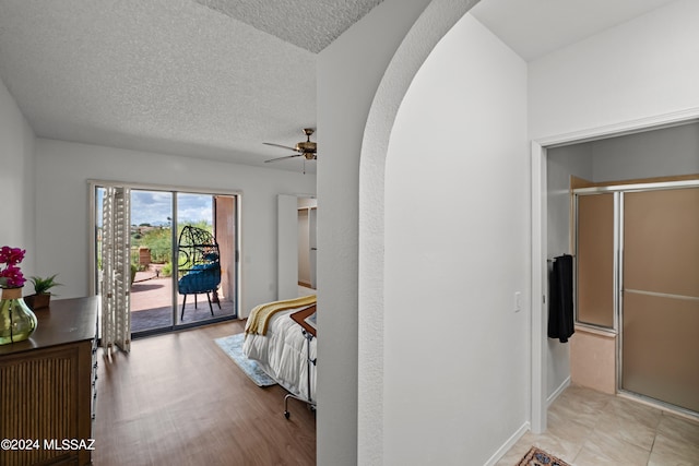 bedroom featuring access to outside, ceiling fan, a textured ceiling, and light wood-type flooring