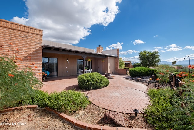 back of property featuring a patio