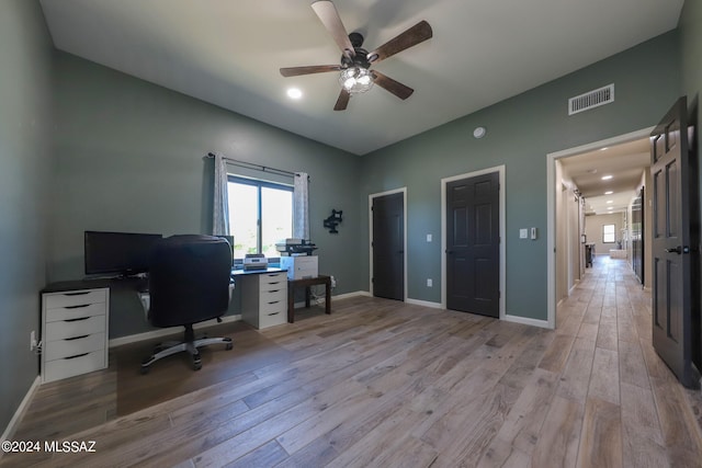 office space with ceiling fan, light wood-style flooring, and baseboards