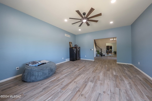 interior space with stairway, wood finished floors, visible vents, and baseboards