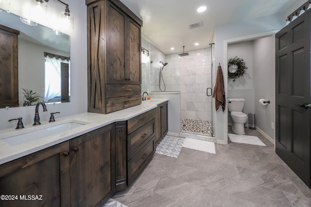 bathroom featuring visible vents, toilet, a stall shower, vanity, and baseboards