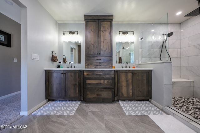 full bath with a walk in shower, double vanity, and a sink