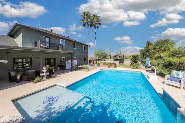 view of swimming pool with central AC, a patio area, fence, and a fenced in pool