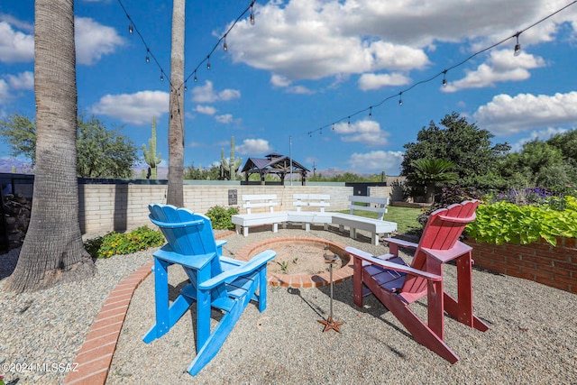 view of patio / terrace featuring a fire pit and fence