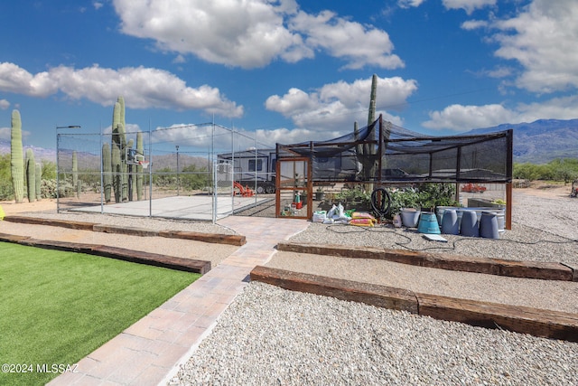 exterior space featuring an outdoor structure and fence