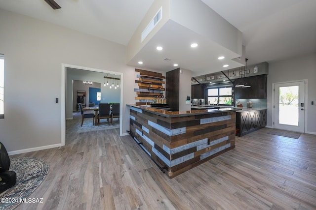 interior space with light wood-type flooring, baseboards, and recessed lighting