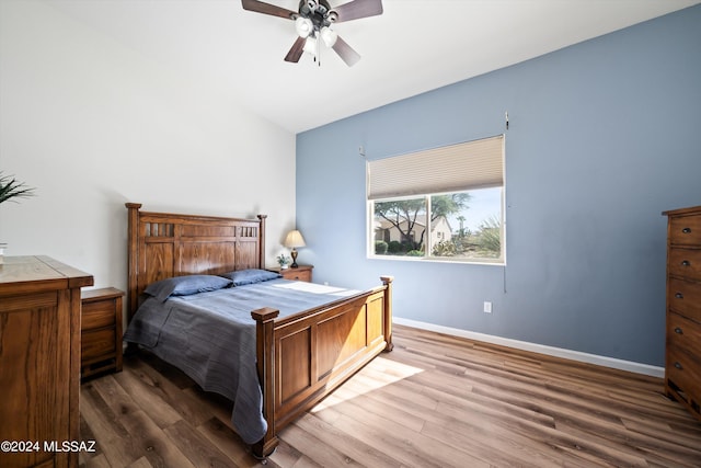 bedroom with baseboards, ceiling fan, and wood finished floors