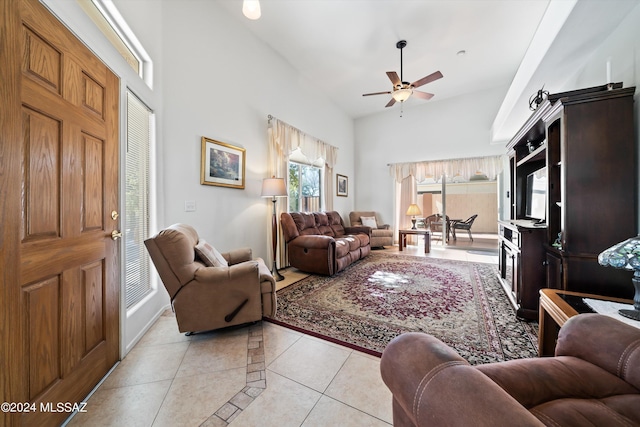living room with a ceiling fan, light tile patterned floors, and high vaulted ceiling