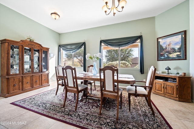 dining space with a chandelier and light tile patterned floors