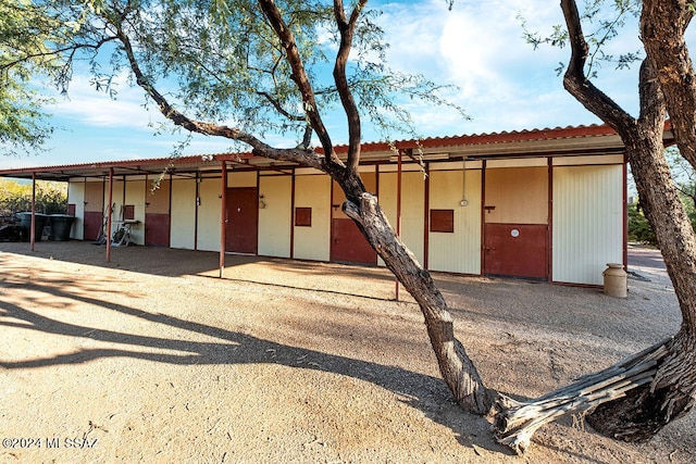 view of front of property with a carport and an outdoor structure