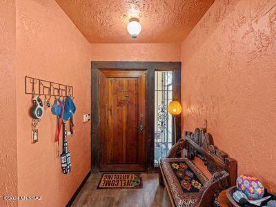 entryway featuring wood-type flooring and a textured ceiling