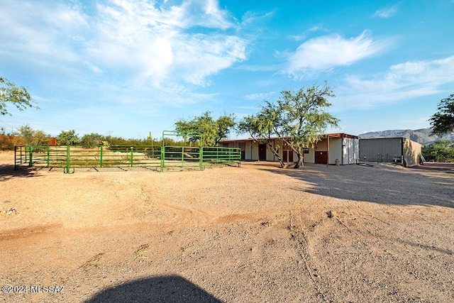 view of yard with an outdoor structure and a rural view