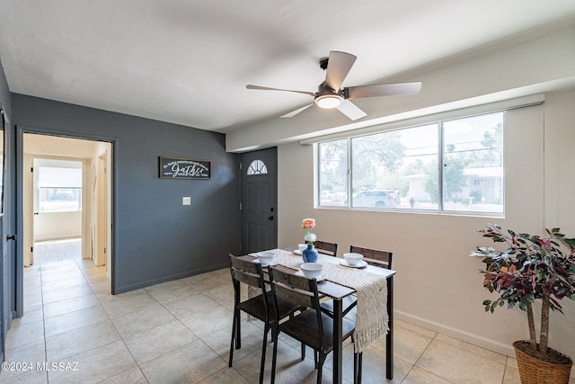 tiled dining area featuring a healthy amount of sunlight and ceiling fan