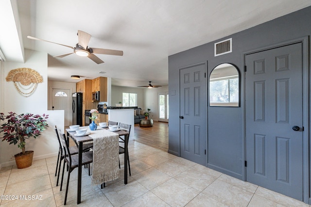 tiled dining area featuring ceiling fan