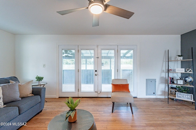 living room with light hardwood / wood-style flooring, ceiling fan, french doors, and a wealth of natural light