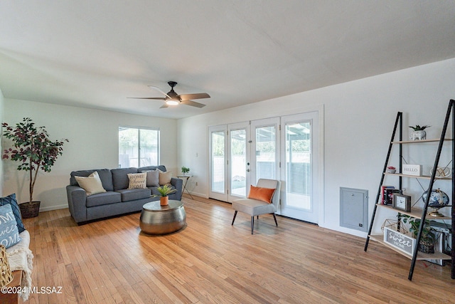 living room with light wood-type flooring, ceiling fan, and french doors