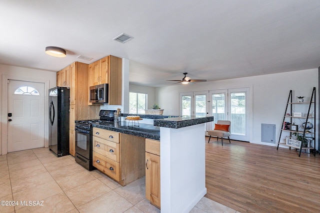 kitchen with ceiling fan, light hardwood / wood-style flooring, kitchen peninsula, and black appliances