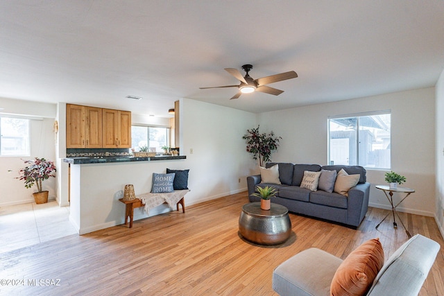 living room featuring light hardwood / wood-style floors and ceiling fan