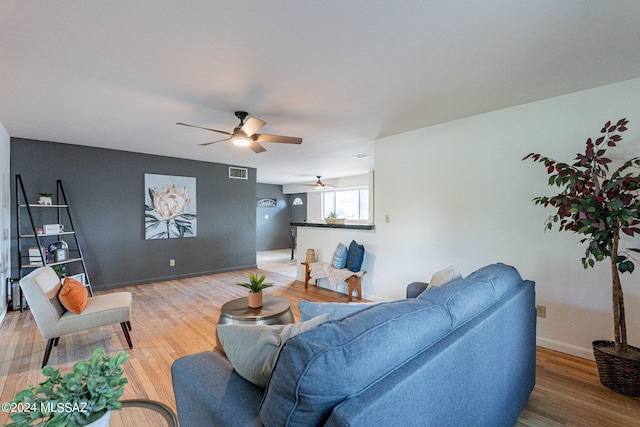 living room with ceiling fan and hardwood / wood-style floors