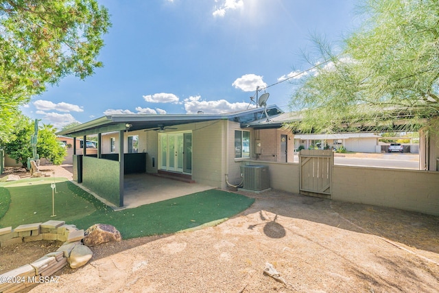 rear view of property featuring ceiling fan, central AC unit, a patio area, and french doors