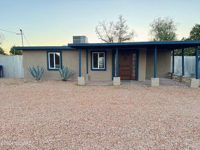 view of front of property with cooling unit and covered porch