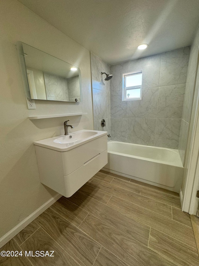 bathroom with vanity and tiled shower / bath combo