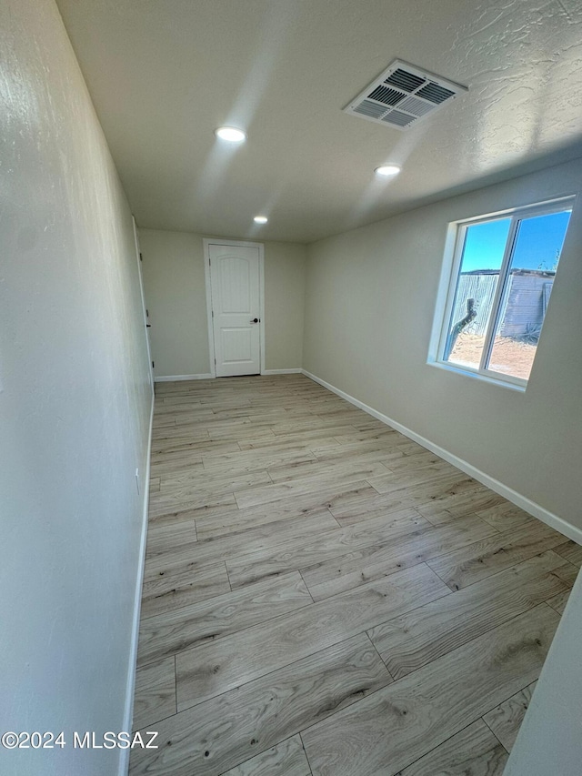 spare room with light wood-type flooring