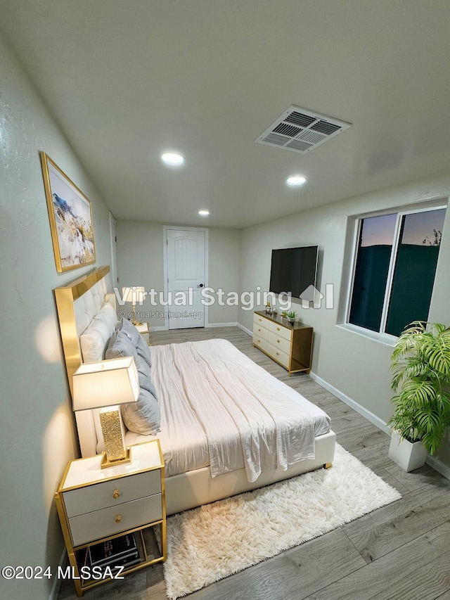 bedroom with hardwood / wood-style floors