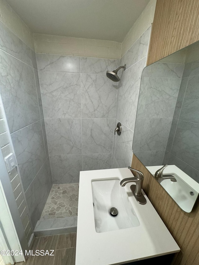 bathroom with vanity and tiled shower