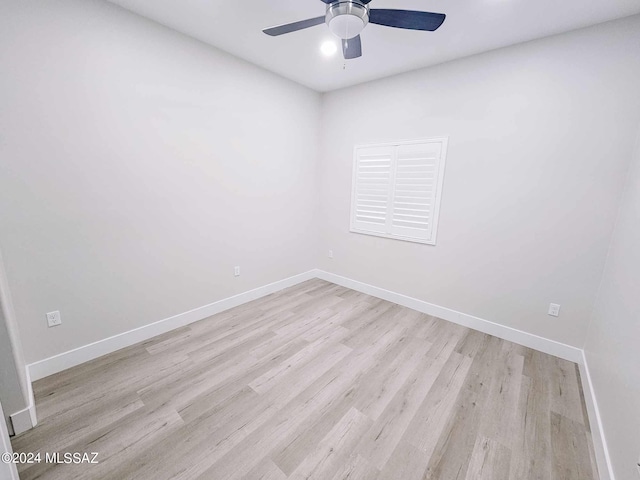 empty room with light hardwood / wood-style floors and ceiling fan