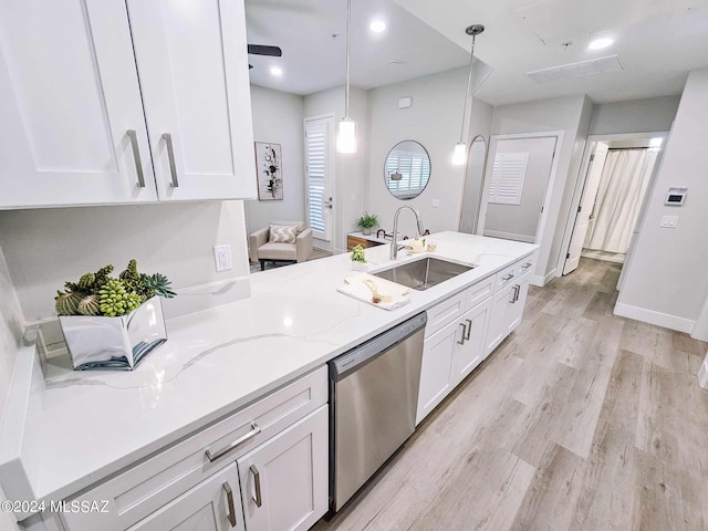 kitchen with white cabinets, sink, decorative light fixtures, dishwasher, and light stone countertops